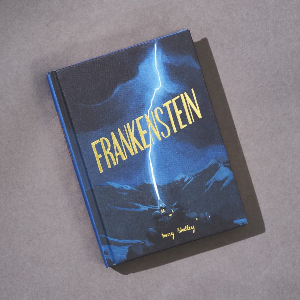 Book titled 'Frankenstein' with a blue cover and yellow text on a gray background