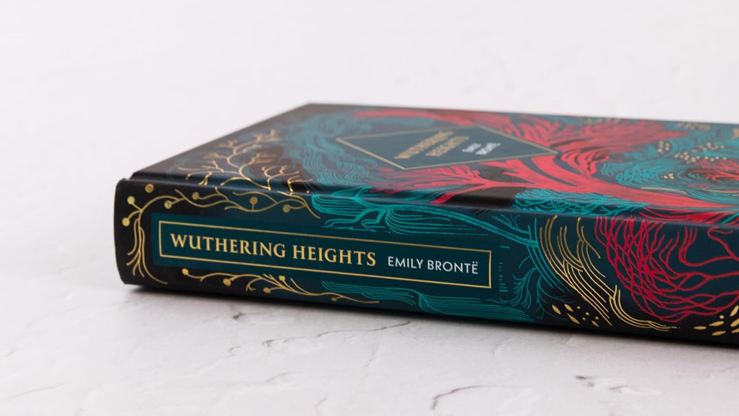 Book titled 'Wuthering Heights' by Emily Bronte with decorative cover on a light background