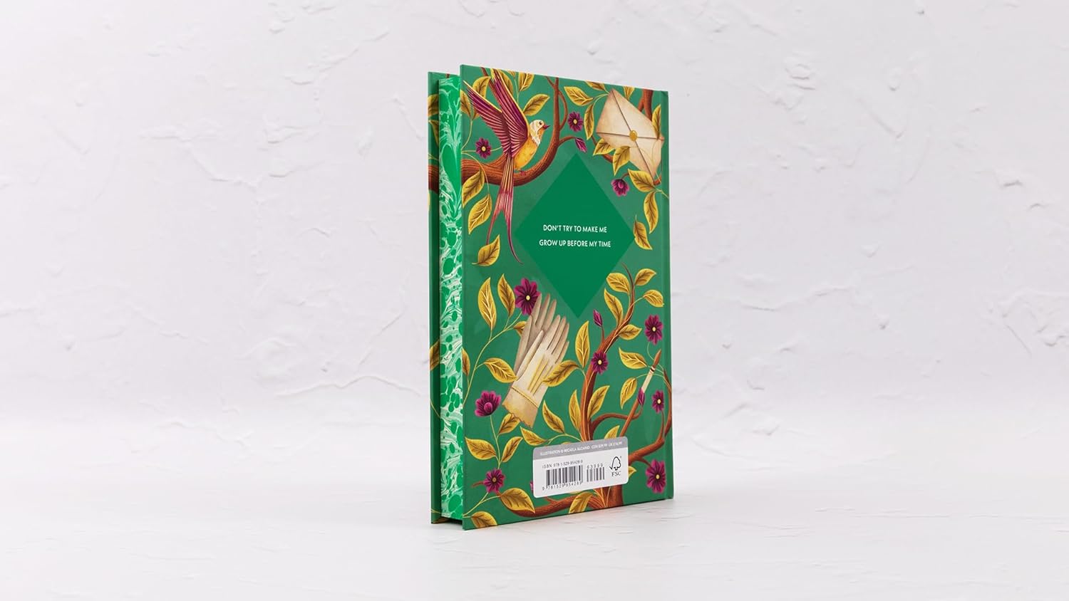 Decorative notebook with floral design on a white background