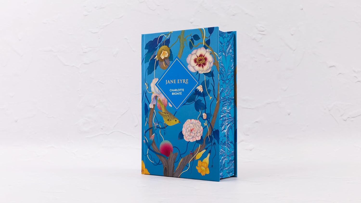 Floral design book or notebook with a blue cover on a white background