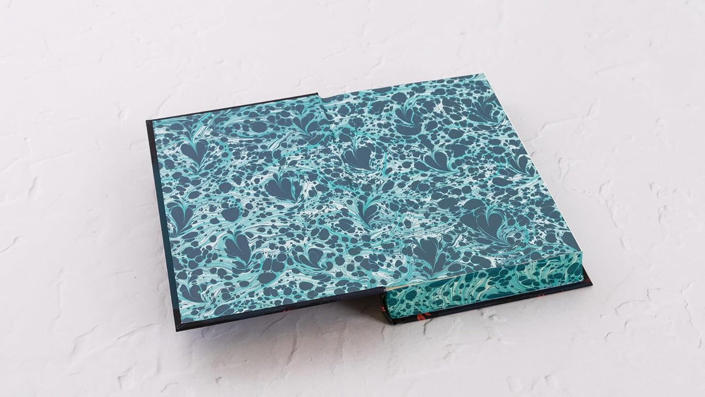 Folded fabric with blue floral pattern on a light gray background