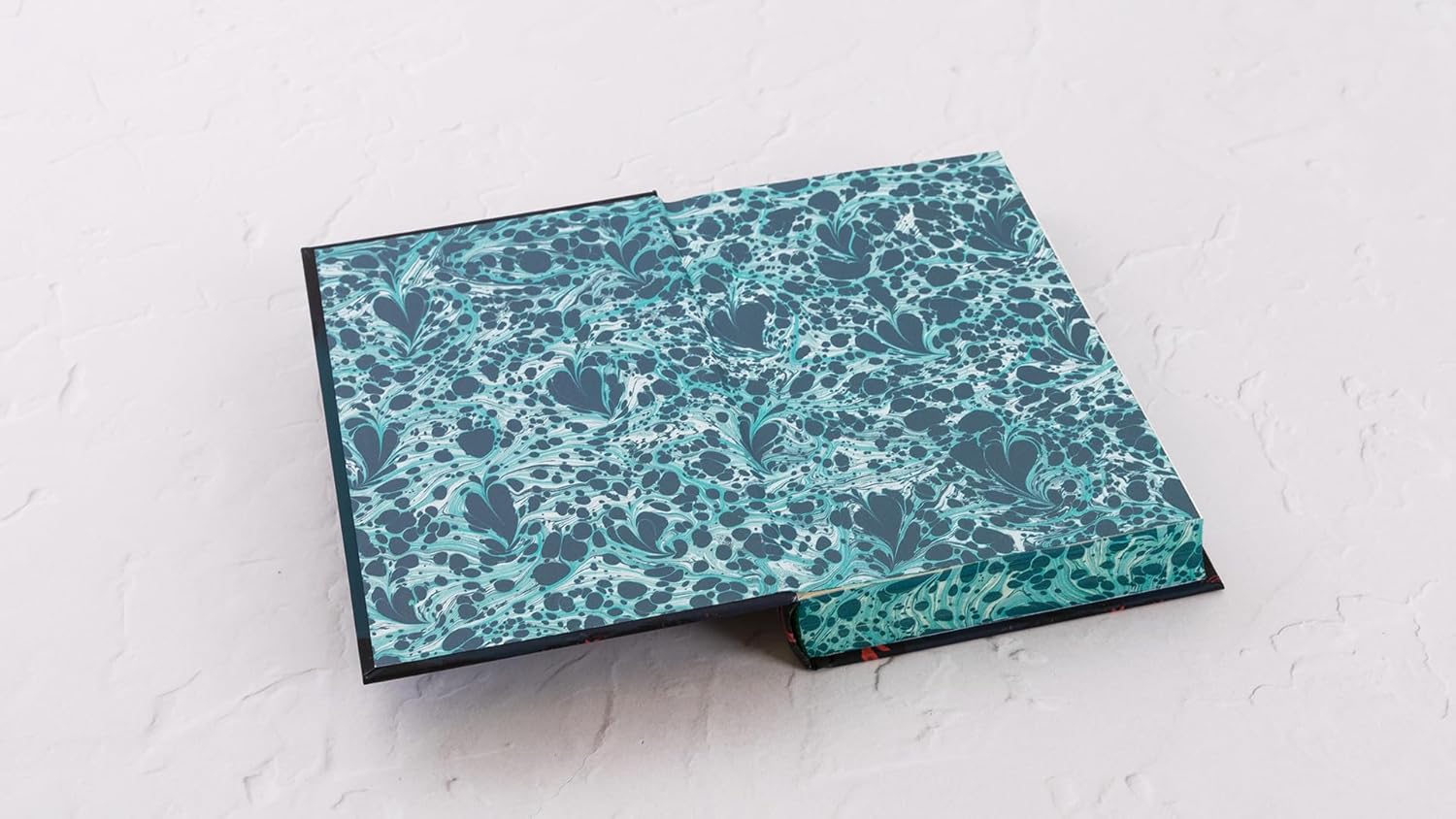 Folded fabric with blue floral pattern on a light gray background