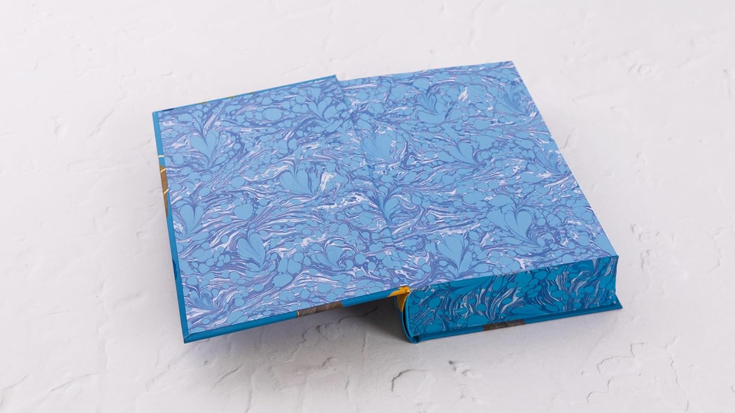Blue marbled notebook on a white surface