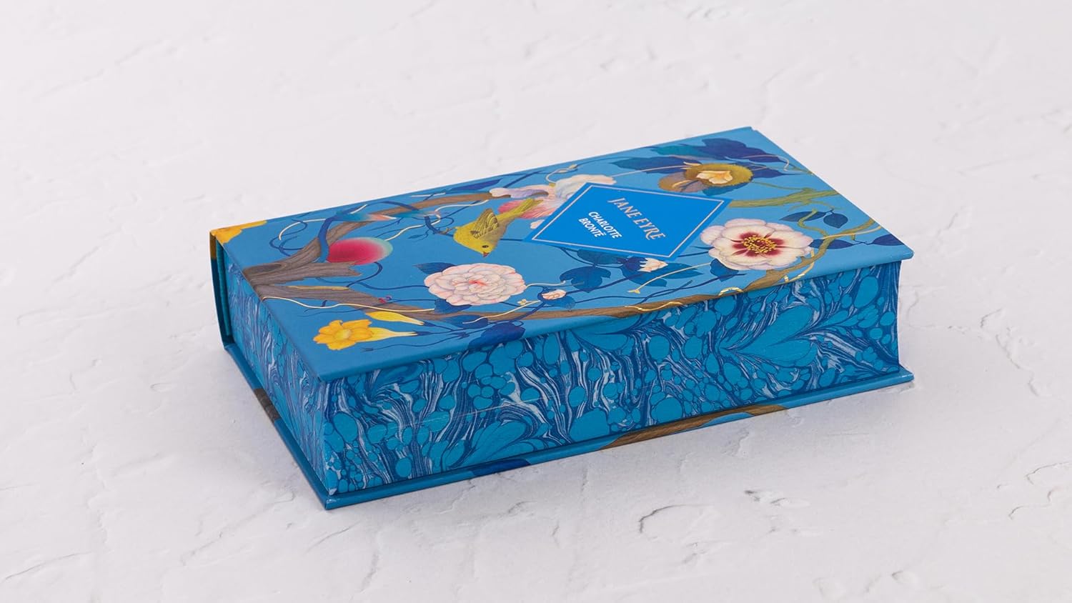 Decorative blue box with floral designs on a light gray background